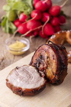 grilled rolled pork on a cutting board