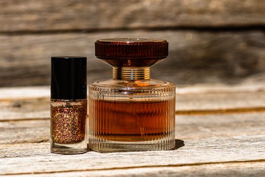 Glittery colorful and bright nail polish and elegant perfume bottle isolated with copy space.