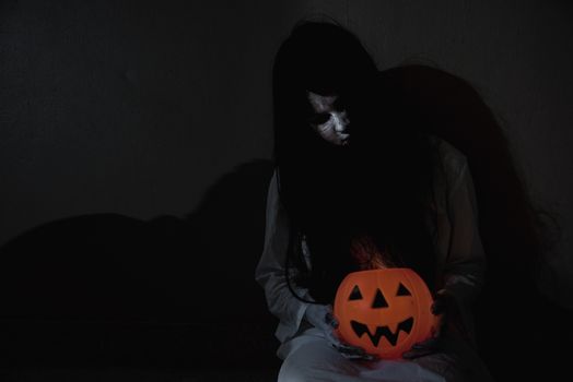 Woman ghost horror have hand holding her pumpkin, halloween concept