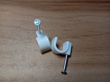 white colored wire pin on wooden table