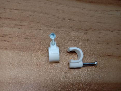 white colored wire pin on wooden table