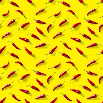 Red hot chilli seamless peppers pattern. Seamless pattern made of red chili or chilli on yellow background. Minimal food pattern. Food background.