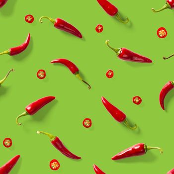 Red hot chilli seamless peppers pattern. Seamless pattern made of red chili or chilli on green background. Minimal food pattern. Food background.