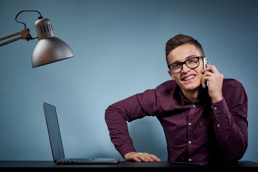 Business man talking on the phone in the office open laptop manager communication model. High quality photo