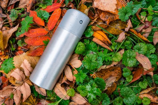 A can of deodorant or air freshener thrown out on the lawn in the autumn grass