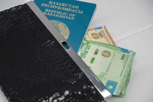 Tenge money with passport and wallet are on the table. Tenge in Kazakhstan. Tenge KZT, Bank of Kazakhstan.