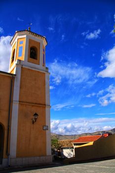 Church facade of the town of Hondon de Las Nieves in Alicante, Spain under blue sky