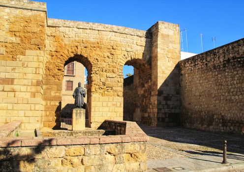 Antique old wall remains in Cordoba, Spain under blue sky