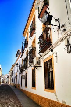 Narrow streets and majestic facades in Cordoba city, Spain.