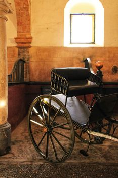 Old carriages in a house in Cordoba, Spain