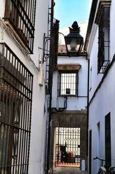 Narrow streets and majestic facades in Cordoba city, Spain.