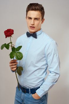 romantic man with red rose and light shirt pants suit. High quality photo