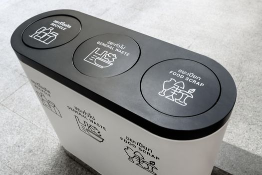 modern separate recycling bin at shopping mall, trash container with icons of recycle, general waste and food scrap