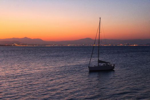 Sailboat anchored in the island of Tabarca, Alicante, at dusk in summer