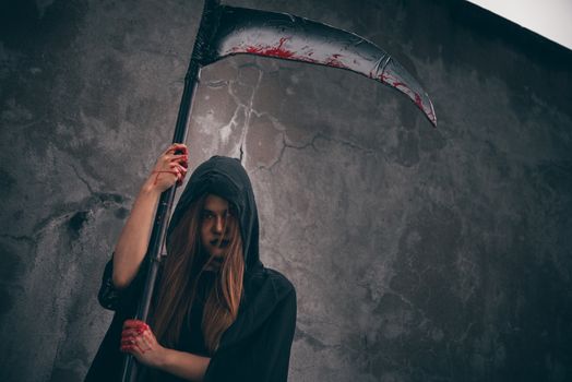 Woman ghost horror her have scythe on hand in forest, halloween day concept