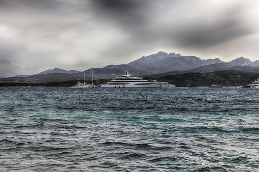 Luxury yachts standing in front of La Celvia, one of the most beautiful beaches in Costa Smeralda, Sardinia, Italy