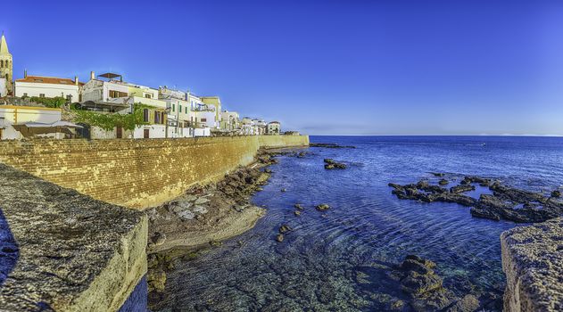 Panoramic view at sunset over the historic ramparts, one of the main sightseeing in Alghero, famous center and holiday resort in northwestern Sardinia, Italy