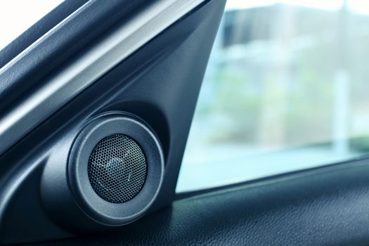 interior side door speaker in modern car, tweeter audio sound system, selective focus
