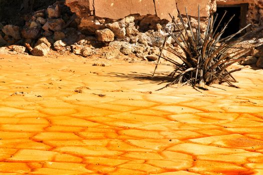 Colorful orange sediments deposited in a dry lake of an old abandoned mine in Mazarron, Spain