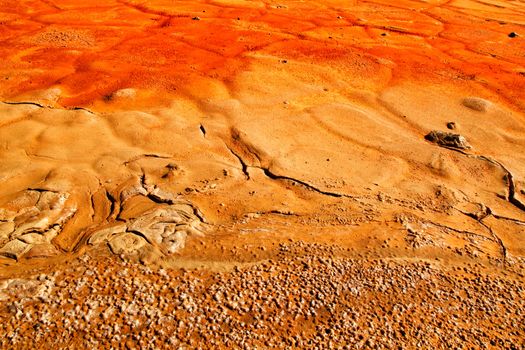 Colorful orange sediments deposited in a dry lake of an old abandoned mine in Mazarron, Spain