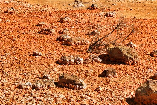 Colorful orange sediments deposited in a dry lake of an old abandoned mine in Mazarron, Spain