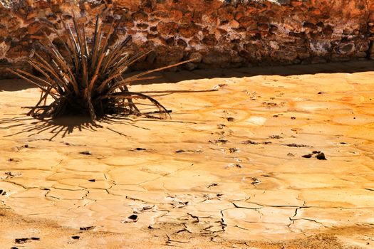 Colorful orange sediments deposited in a dry lake of an old abandoned mine in Mazarron, Spain
