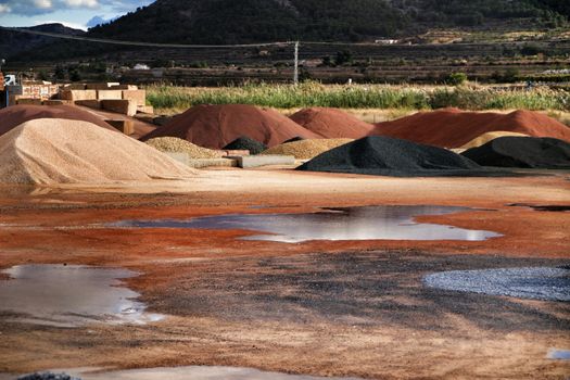 Colorful construction aggregate mountains in Alicante, Spain