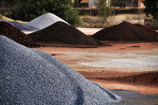 Colorful construction aggregate mountains in Alicante, Spain
