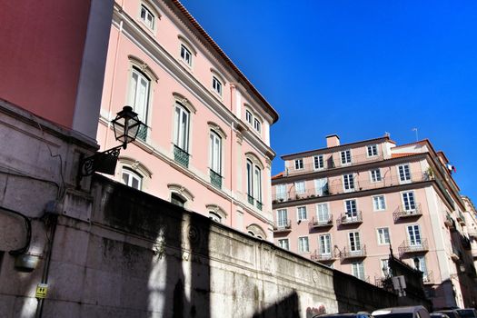 Old colorful and beautiful facades with vintage streetlight in Lisbon streets in Spring.