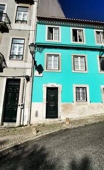 Old colorful and beautiful facades with vintage streetlight in Lisbon streets in Spring.