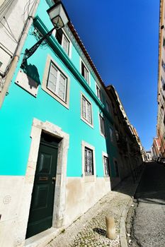 Old colorful and beautiful facades with vintage streetlight in Lisbon streets in Spring.