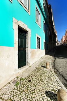 Old colorful and beautiful facades with vintage streetlight in Lisbon streets in Spring.