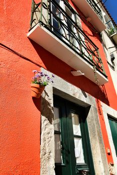 Old colorful and beautiful facades with vintage streetlight in Lisbon streets in Spring.