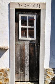 Old and colorful wooden door with iron details in Lisbon, Portugal