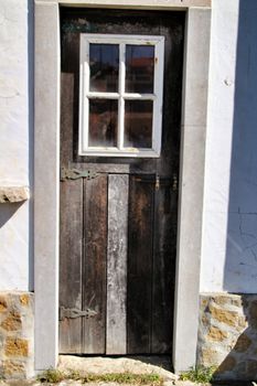 Old and colorful wooden door with iron details in Lisbon, Portugal