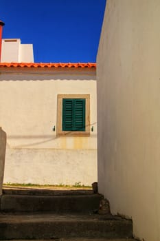 Beautiful narrow streets, white houses and roofs of Azenhas do Mar village in Lisbon, Portugal