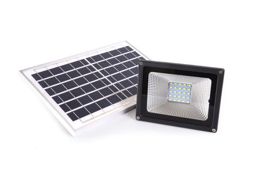 Small solar panel and spotlight is alternative energy for home on white background.