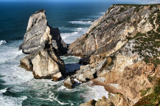 Beautiful Ursa beach with its colossal rock formations and the blue Atlantic Ocean