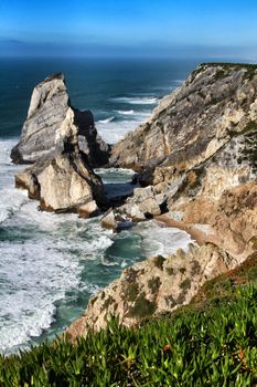 Beautiful Ursa beach with its colossal rock formations and the blue Atlantic Ocean