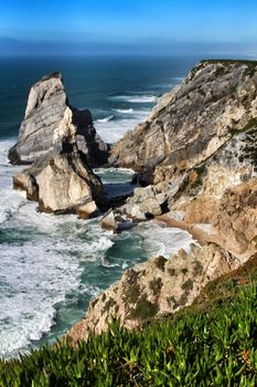 Beautiful Ursa beach with its colossal rock formations and the blue Atlantic Ocean