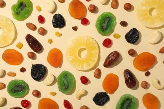 Tasty dried fruits on beige background, top view