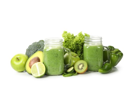 Green vegetables, fruits and jar of smoothie isolated on white background