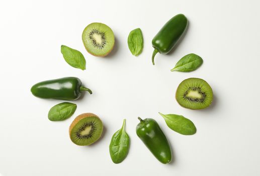 Kiwi, spinach and pepper on white background