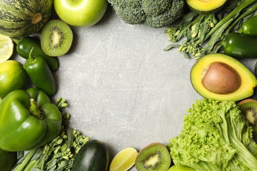 Green vegetables and fruits on gray background
