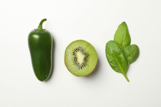 Kiwi, spinach and pepper on white background