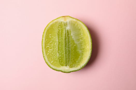 Half of fresh lime on pink background
