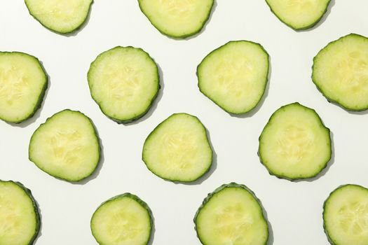 Cucumber slices on white background, top view