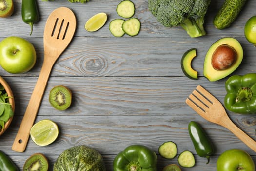 Cutlery, vegetables and fruits on wooden table