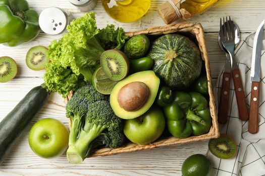 Concept of healthy food with vegetables and fruits on white wooden table