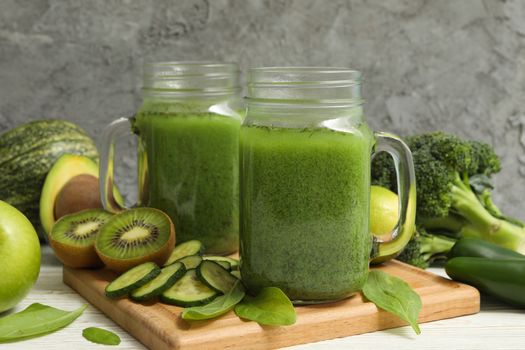 Concept of healthy food with smoothie, vegetables and fruits on wooden table